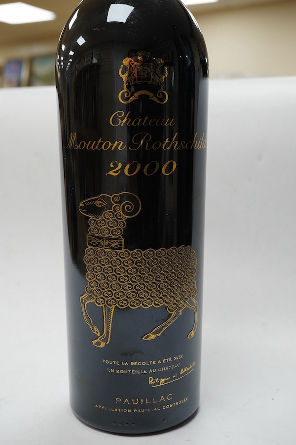 One bottle of Chateau Mouton Rothschild, Pauillac, 2000 - Condition - Private Heathfield Cellar. Two small nicks/tears to label verso.